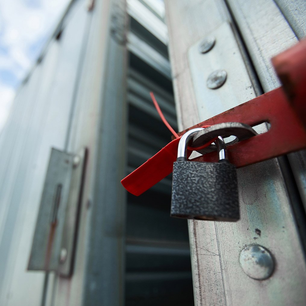 Close-up of a padlock on a secure gate