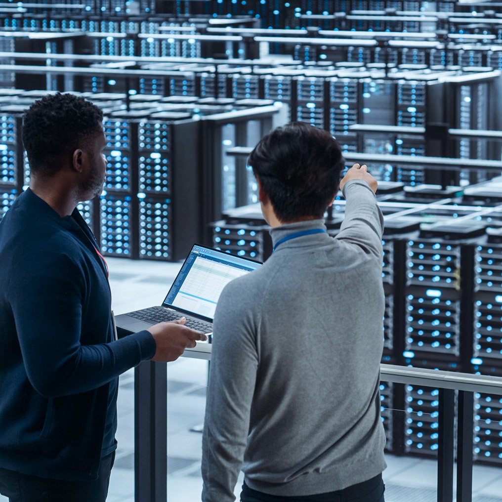 Two people review a server facility