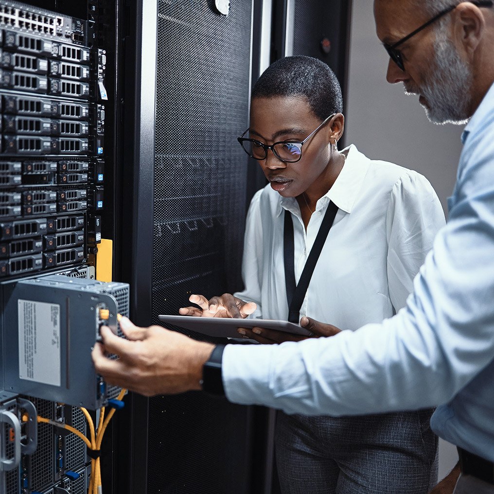 Two people review server hardware