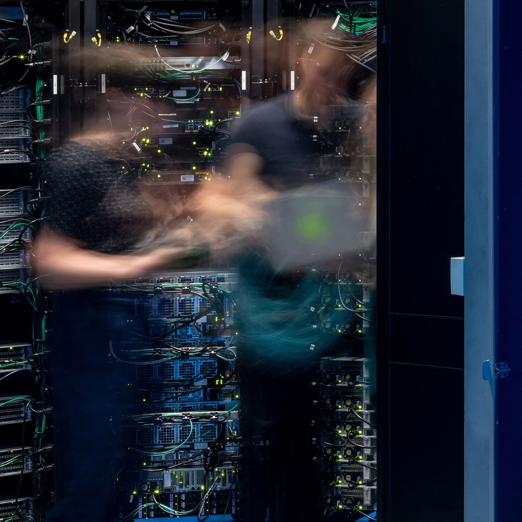 Blurry image of people working in a server farm