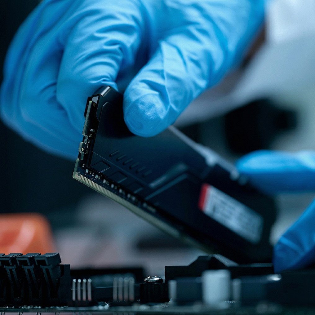 Close-up image of a gloved hand holding computer hardware