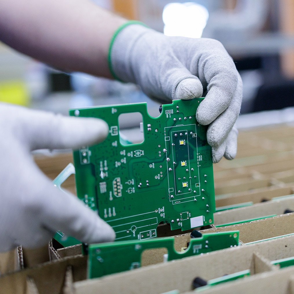 Close-up of gloved hands holding a computer card