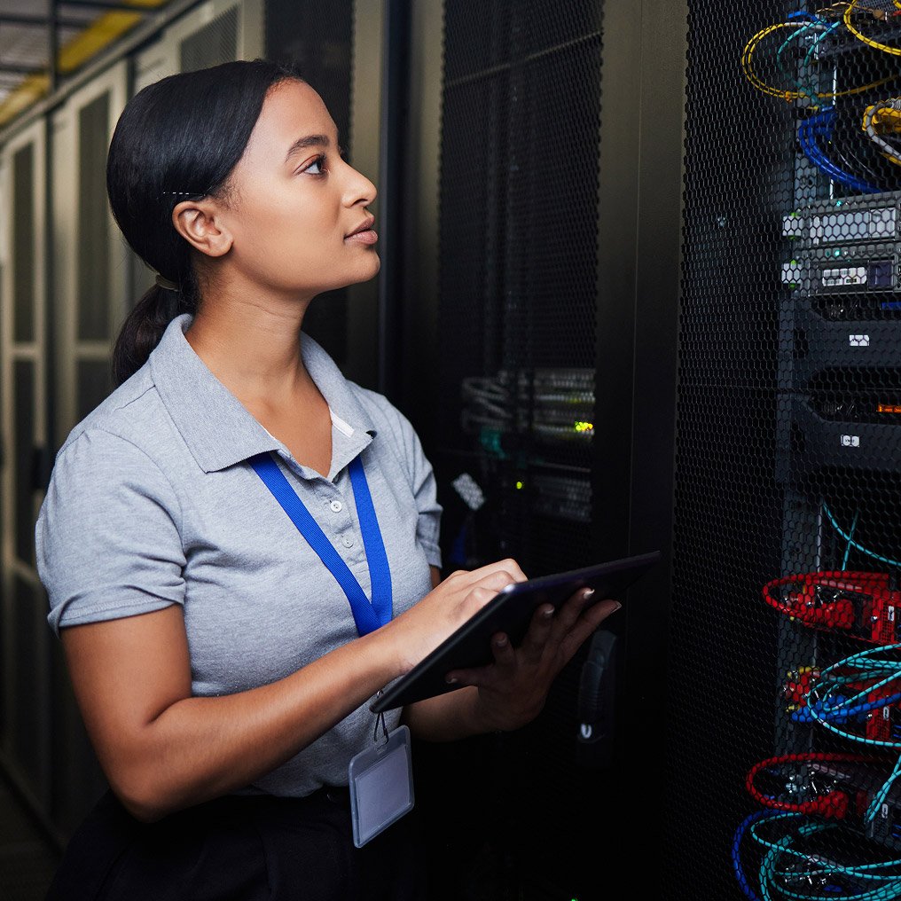 A professional woman inspects server hardware