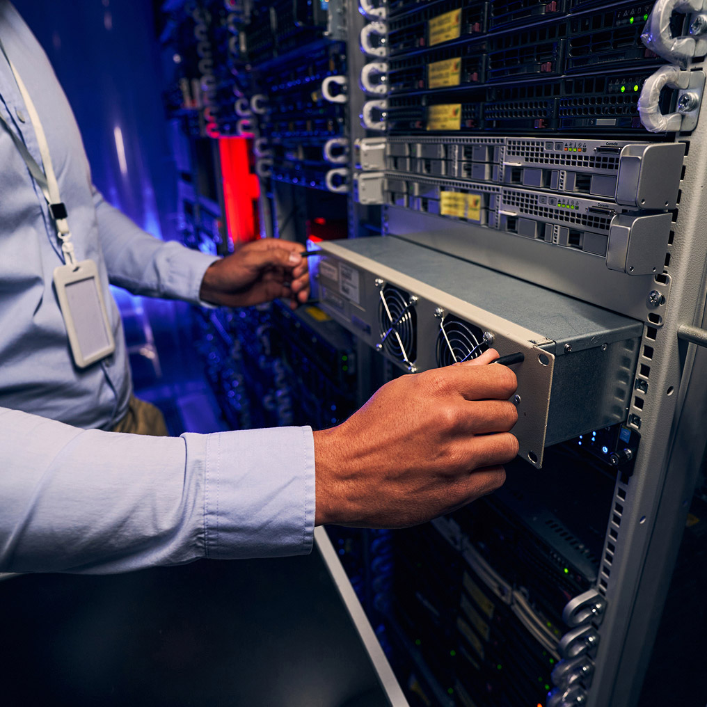 Close-up of a man removing server hardware
